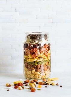 a glass jar filled with nuts and vegetables