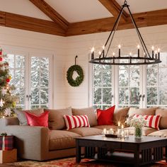 a living room filled with furniture and christmas decorations