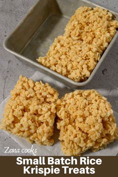 three pieces of rice krispy treats in a metal pan on a white counter top