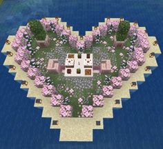 an aerial view of a heart - shaped house in the middle of flowers and trees