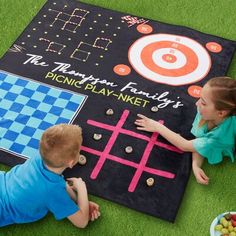 two children playing with a giant board game