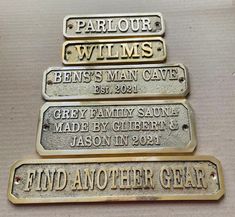 four metal name tags on top of each other