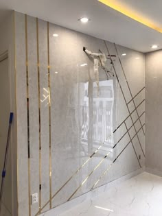 an empty room with white marble walls and gold trimmings on the glass wall