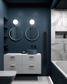 a bathroom with two round mirrors on the wall