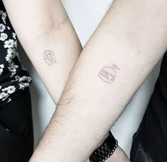 two people with matching tattoos on their arms