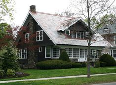 a black and white house surrounded by trees