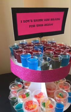 there is a display with cups and candy on it