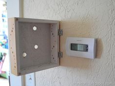 an alarm clock mounted to the side of a wall