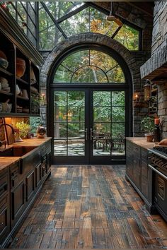 a kitchen with an arched glass door and wooden flooring is pictured in this image