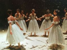 a group of young ballerinas standing in the snow