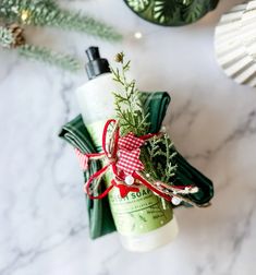 a bottle of lotion sitting on top of a counter next to christmas decorations and ornaments