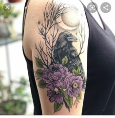 a woman with a tattoo on her arm has flowers and a crow in the background