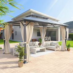 an outdoor living area with white furniture and curtains