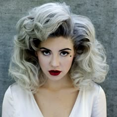 a woman with grey hair and red lipstick