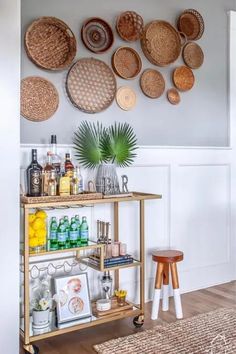 a bar cart with lots of baskets on the wall