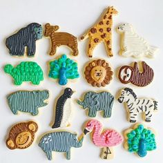 cookies decorated like animals and zebras are displayed on a white table with an instagramr