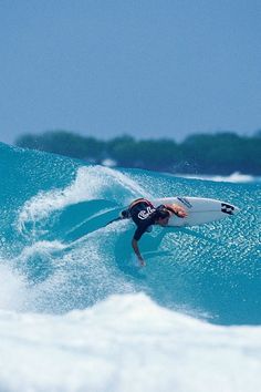 a man riding a wave on top of a surfboard