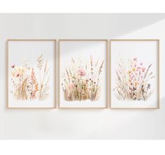 three floral paintings hanging on the wall