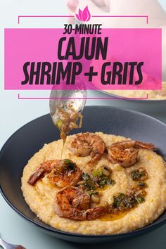 shrimp and grits being drizzled on top of the grits in a bowl