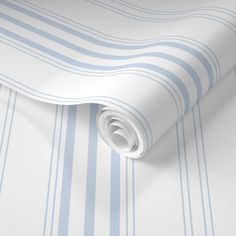 a blue and white striped wallpaper with vertical stripes on it's sides, as well as a roll of tape