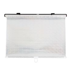 a white roller blind with an intricate design on the top and bottom, hanging from a metal rod