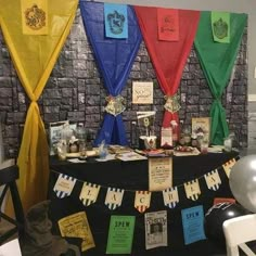 a table topped with lots of different colored flags and books on it's sides