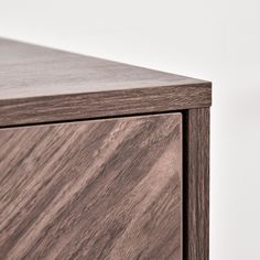 a close up view of the top of a wooden cabinet with wood grained finish