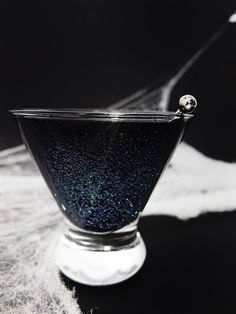 a black and blue liquid in a glass bowl