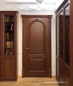 an empty room with bookshelves, cabinets and a book case in it's corner