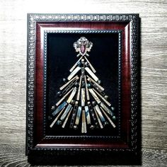 a christmas tree made out of pencils in a wooden frame