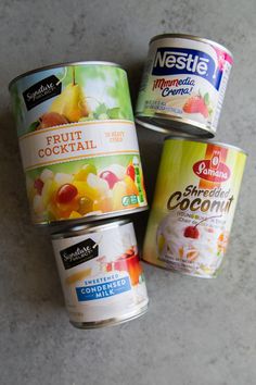 three cans of ice cream sitting next to each other on top of a countertop