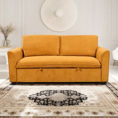 an orange couch sitting on top of a rug