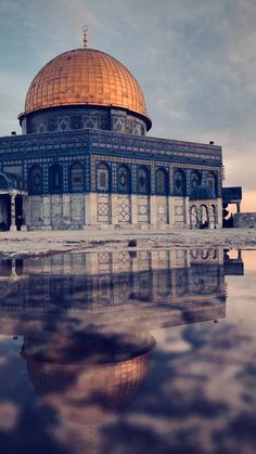 the dome of the rock is reflected in water