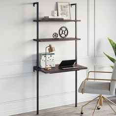 a laptop computer sitting on top of a wooden shelf next to a chair and potted plant