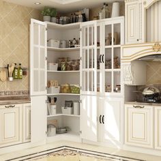 a kitchen with lots of white cupboards and shelves filled with various foodstuffs