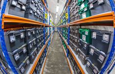 the shelves are filled with many different types of electronic devices and storage bins for sale