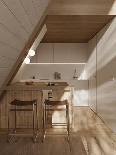 two stools are in front of the kitchen counter and bar area that is made of wood