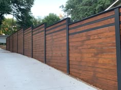 a wooden fence with black slats on it