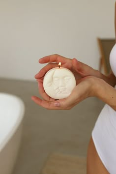 a woman holding a candle in her hand