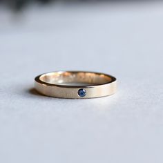 Plain and simple wear-it-every-day band with sapphire.   Metal: 14k Solid Gold Available in White gold, rose gold and yellow gold.  Setting Type: Flush Stone: 2mm sapphire Dimension: 3mm band width  Engraving available.  Final sale for personalized ring.    FREE SHIPPING USA- All of our jewelry will arrive in custom packaging ready for gift giving.  CARE: To prolong the color and shine of your jewelry, avoid contact with perfume, lotion, and water. Store in a bag or jewelry box.  SATISFACTION GUARANTEED All pieces are carefully examined prior to delivery. If item is damaged upon delivery, we will offer full refund. Please first message us regarding your return within 24hrs. Please do send the item back in original packaging. We offer 30 days return policy.  FOLLOW US ON: Instagram: @rosean Gay Engagement Rings, 3mm Wedding Band, Flush Setting, Yellow Gold Sapphire Ring, Hammered Gold Ring, Ring Selfie, Gold Sapphire Ring, Gay Wedding, Ring Stacking