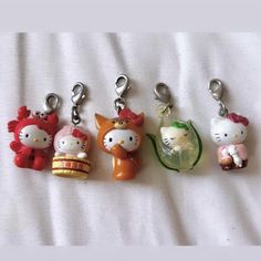 four hello kitty keychains on a white sheet