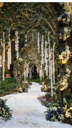 an image of a garden with flowers on the ground and trees in the background that have been decorated