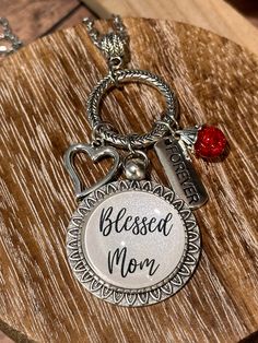 This handcrafted necklace is fondly named "Charmed Ones". This collection has numerous family/friend-themed names available (i.e., Nana, Grammaw, Gigi, Mom, etc.). Be sure to search the name you are looking for.  If you don't see the name you are looking for, it can be custom-made for you. The glass cabochon creation is set in a 25mm pendant tray and includes charms and beads that dangle from a circle connector. The necklace is a 24" long stainless steel chain. NOTE: I work with various suppliers so the style of the pendant tray, circle connector, and charms may vary depending on availability.  Like us on Facebook!  https://www.facebook.com/kkscreationsbykarens.  Also, check out my full online catalog that includes items not listed in my Etsy store.   https://kks-creations-by-karen.myshopi Momma Necklaces, Themed Names, Charmed Ones, Family Friend, Handcrafted Necklace, Steel Chain, Stainless Steel Chain, Charm Necklaces, Charm Necklace