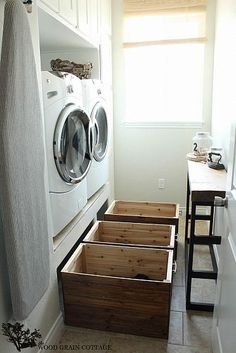 a washer and dryer in a laundry room next to a counter with drawers