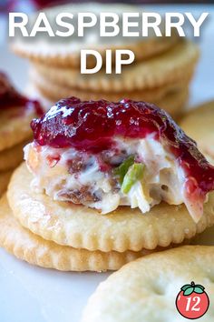 some crackers are stacked on top of each other with cranberry dip in the middle