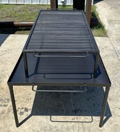 a grill sitting on top of a metal table