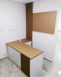 an empty office cubicle with a computer on the desk and a dry erase board attached to the wall