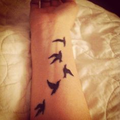 a person's arm with birds on it