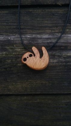 a wooden necklace with a slot design on it