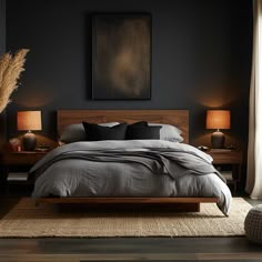 a bedroom with black walls and wooden furniture, including a bed that has two lamps on either side of the headboard